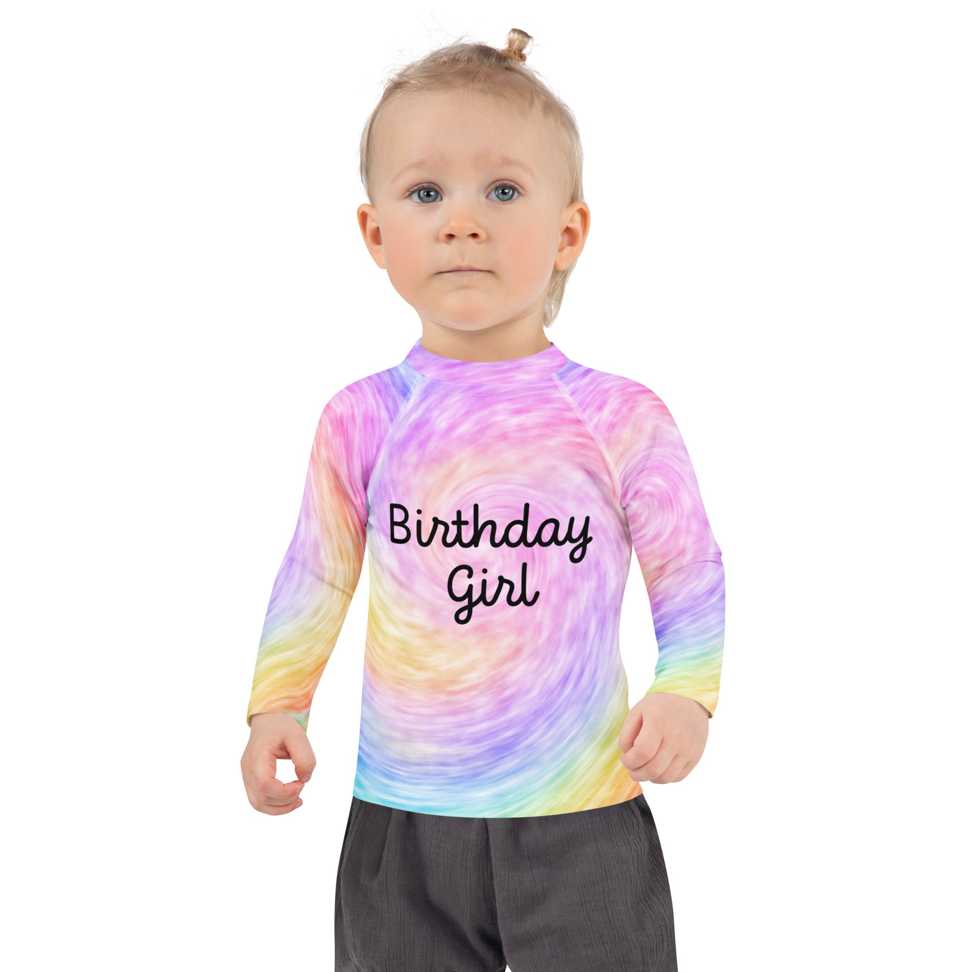 A child wearing a girls faux rainbow tie dye birthday girl long sleeve rash guard swim shirt with UPF 50 plus