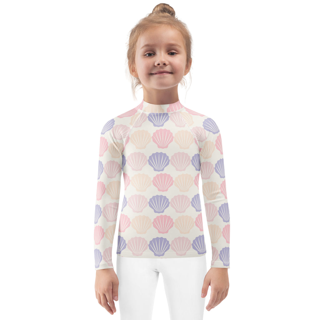 Kids seashell print long sleeve rash guard swim shirt with upf 50 plus featuring pink and lavender seashells on off white