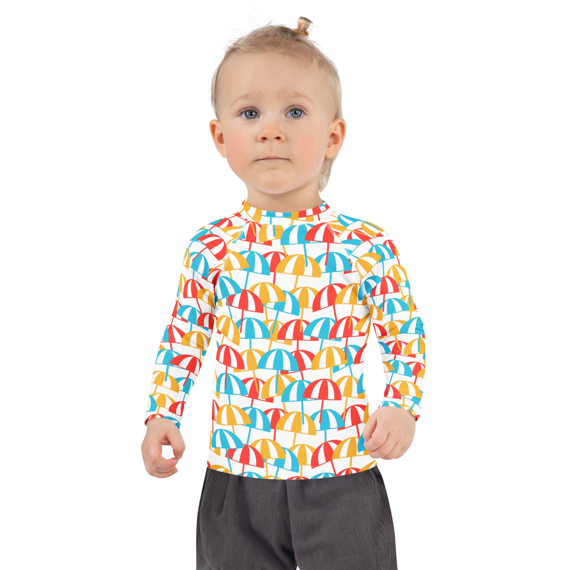 A child wearing a white kids beach umbrella long sleeve rash guard with colorful umbrella pattern and UPF 50+ protection