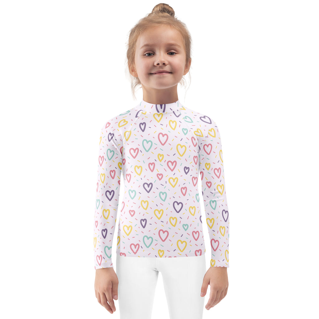 White long-sleeved girls rash guard swim shirt with pastel multicolored hearts pattern and UPF 50 plus protection
