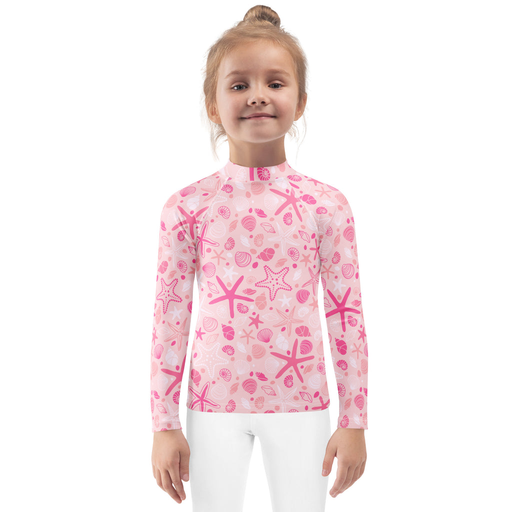 Pink girls long-sleeve rash guard with starfish and seashell pattern offering upf 50 plus sun protection