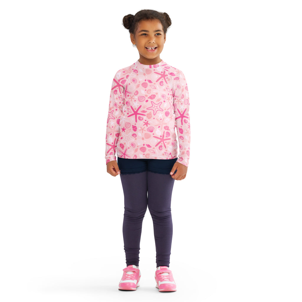 Girls pink long sleeve rash guard swim shirt with playful starfish and seashell pattern and UPF 50 plus protection