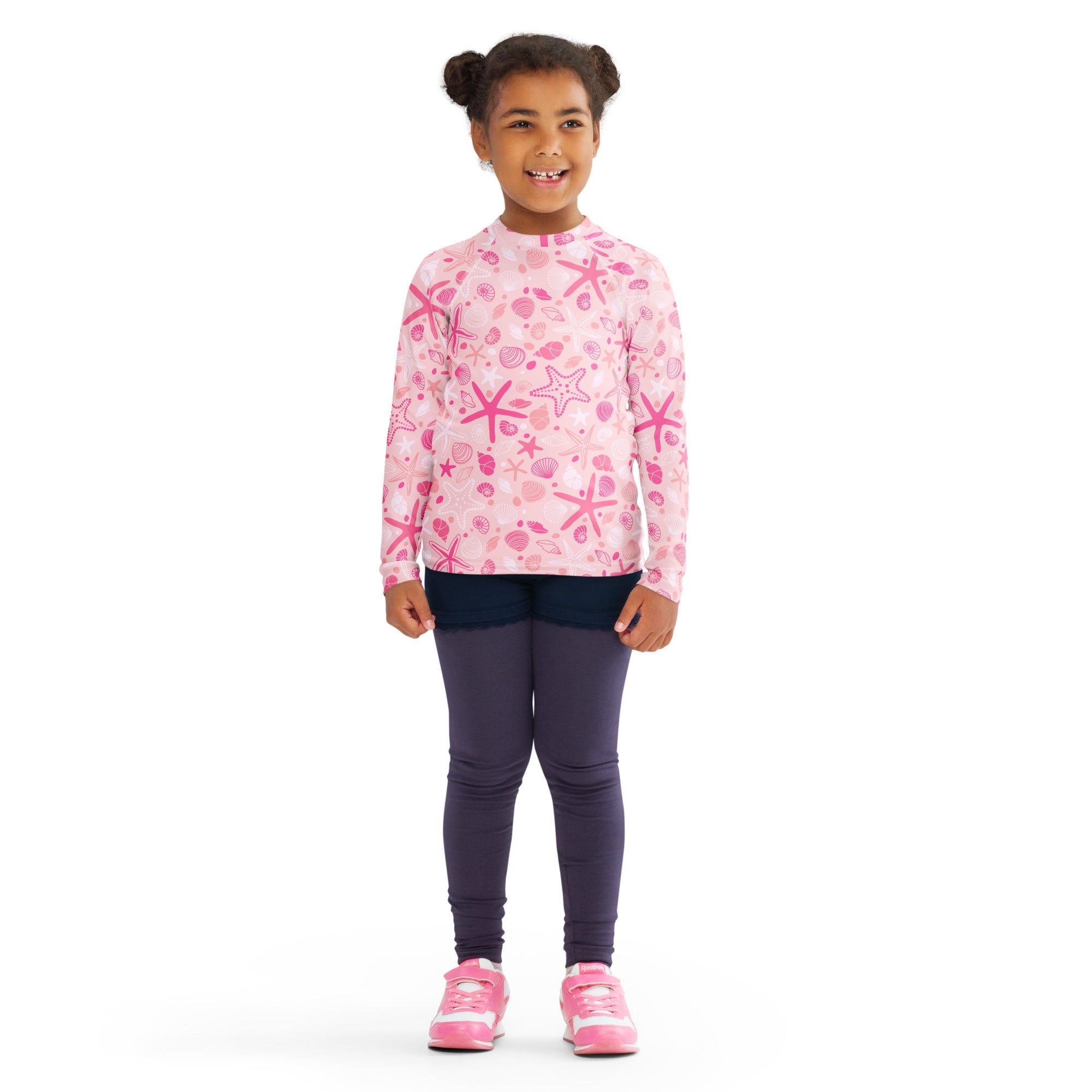 Girls pink long sleeve rash guard swim shirt with playful starfish and seashell pattern and UPF 50 plus protection
