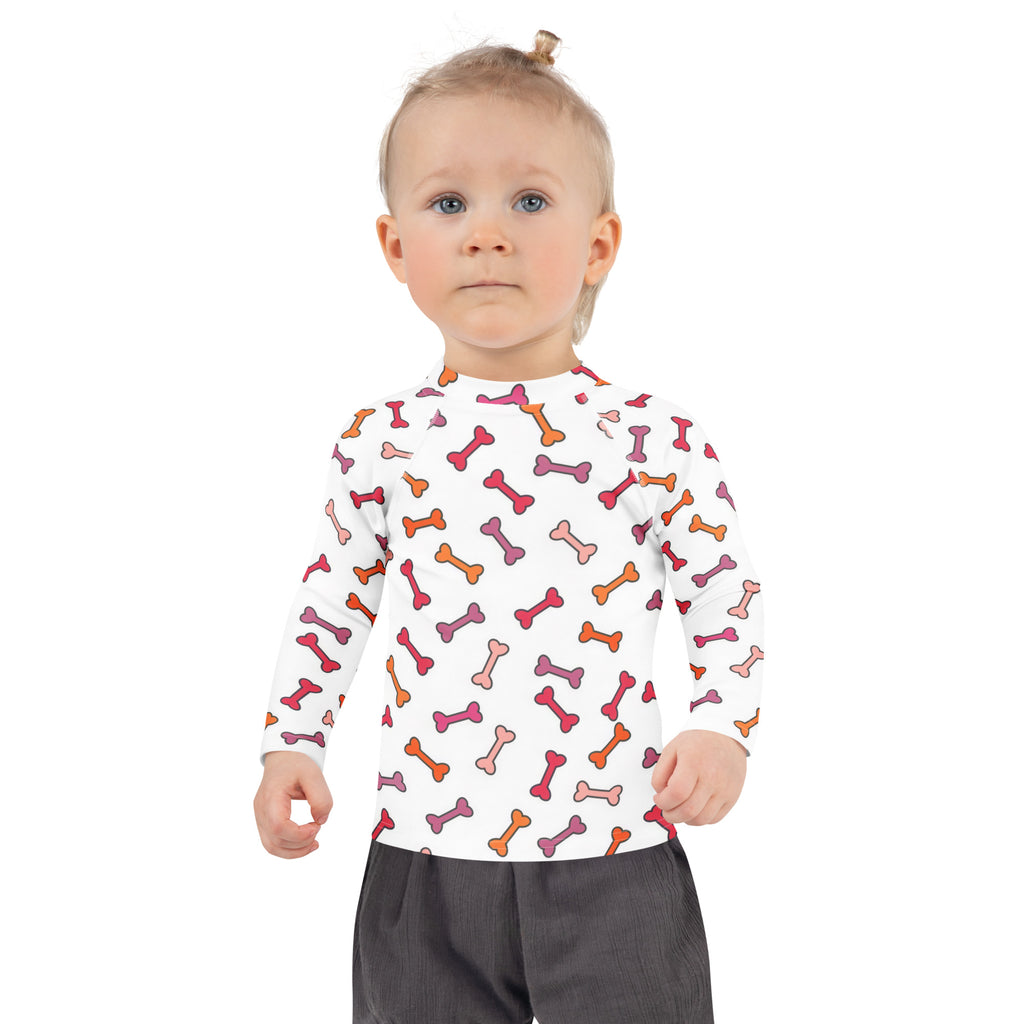 White long-sleeved kids rash guard swim shirt with multicolored dog bone pattern and upf 50 plus sun protection