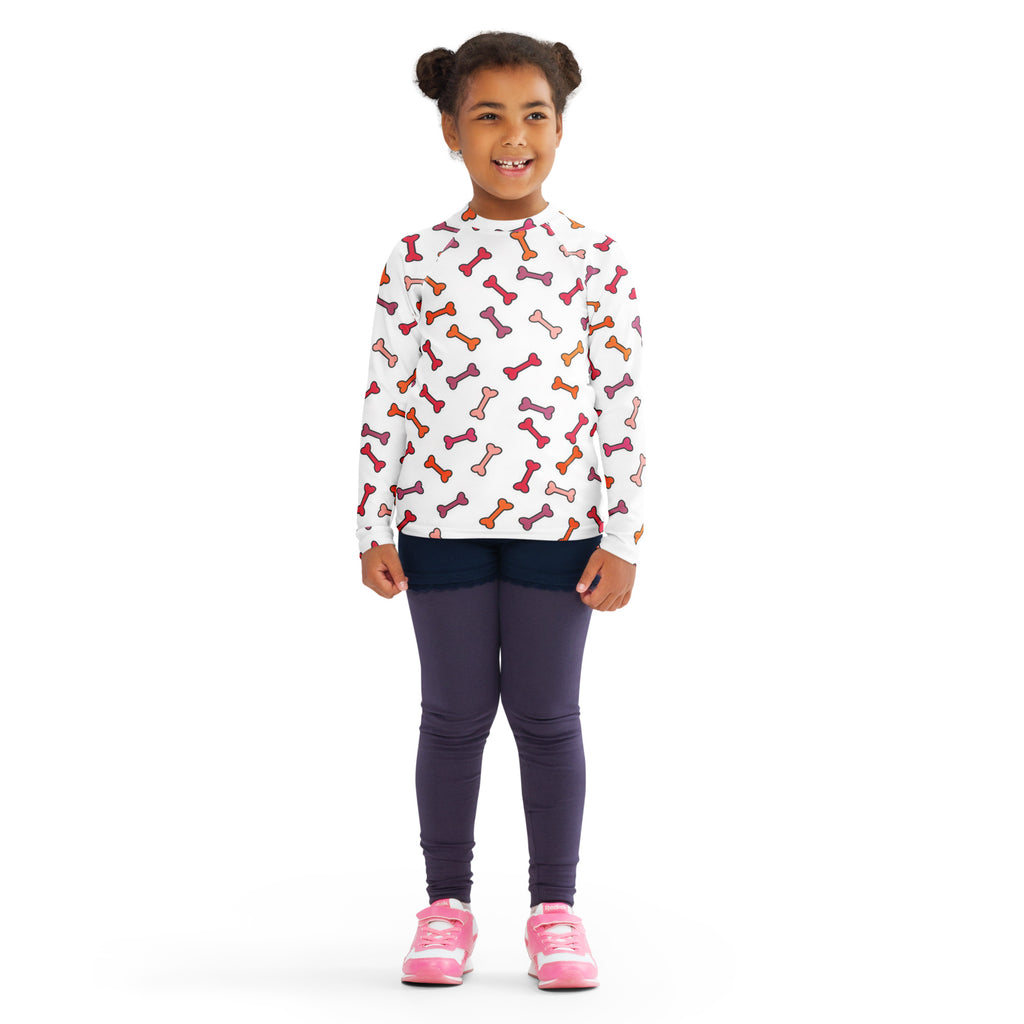White kids long sleeve rash guard swim shirt with playful multicolored dog bone pattern and upf 50+ protection