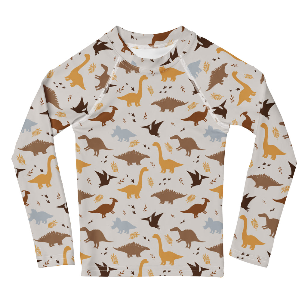Kids dinosaur long sleeve rash guard swim shirt with UPF 50 plus featuring brown tan and gray dinosaur pattern on off-white