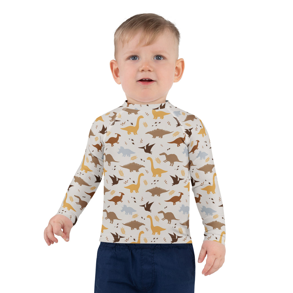 Kids dinosaur long sleeve rash guard swim shirt with upf 50 plus featuring a playful dinosaur pattern in earthy tones
