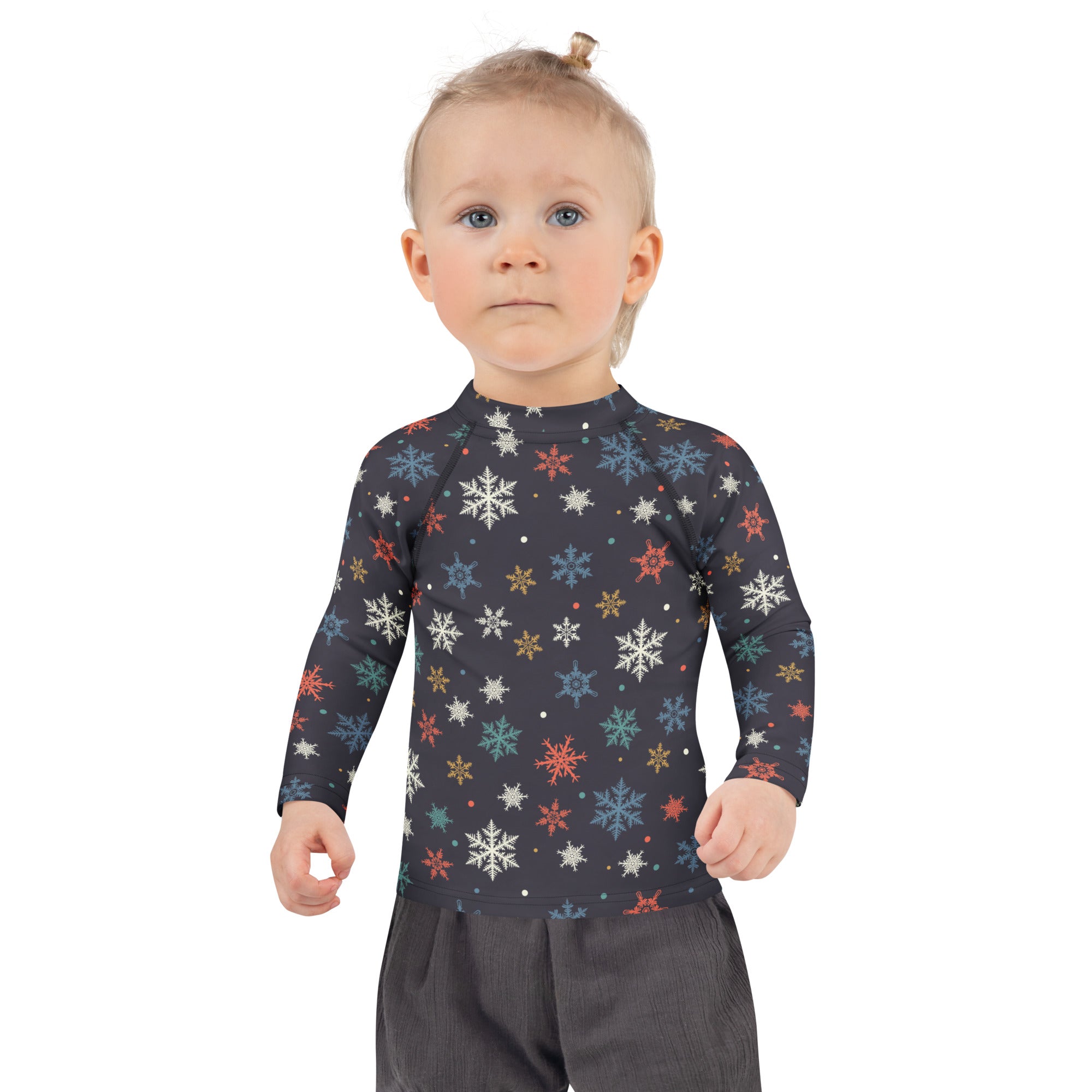 A child wearing a dark navy kids colorful snowflakes long sleeve rash guard swim shirt with upf 50+