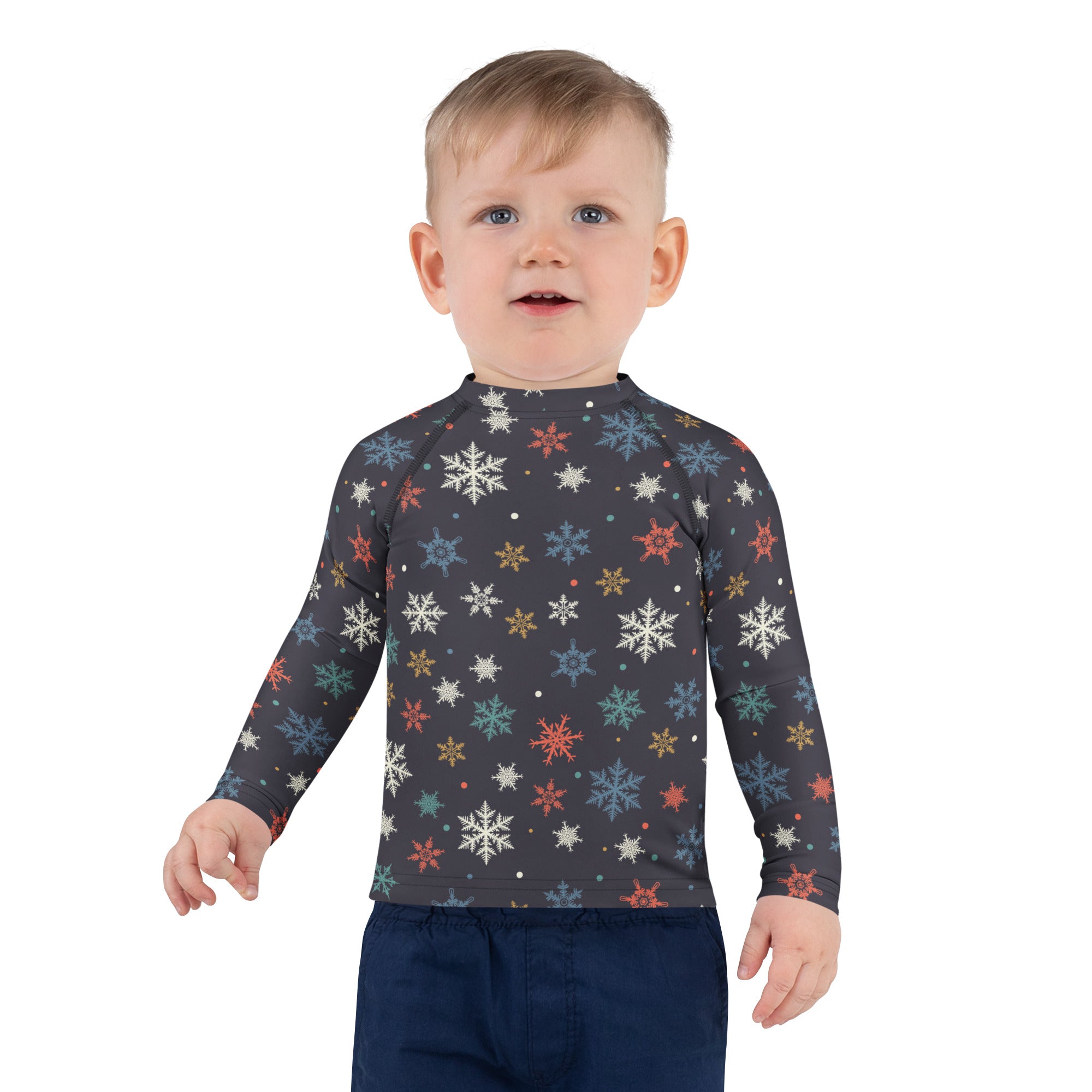 A child wearing a dark gray kids colorful snowflakes long sleeve rash guard swim shirt with UPF 50+ protection