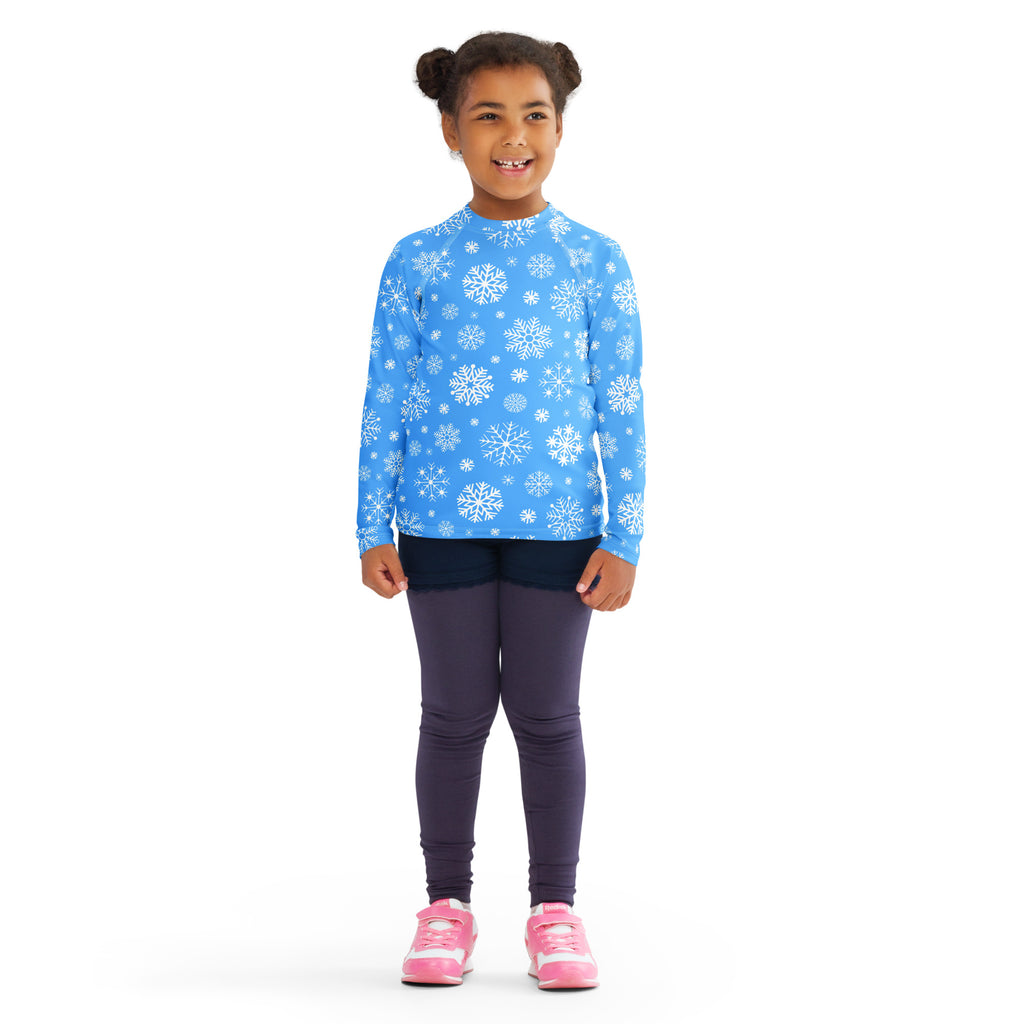 Kids blue long sleeve rash guard swim shirt with white snowflake pattern and UPF 50 plus sun protection