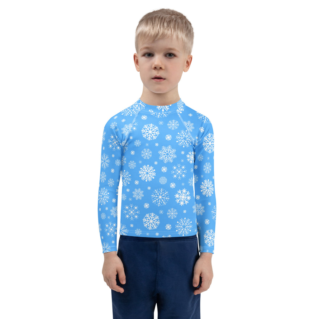 Kids blue snowflake long sleeve rash guard swim shirt with UPF 50 plus featuring a white snowflake pattern