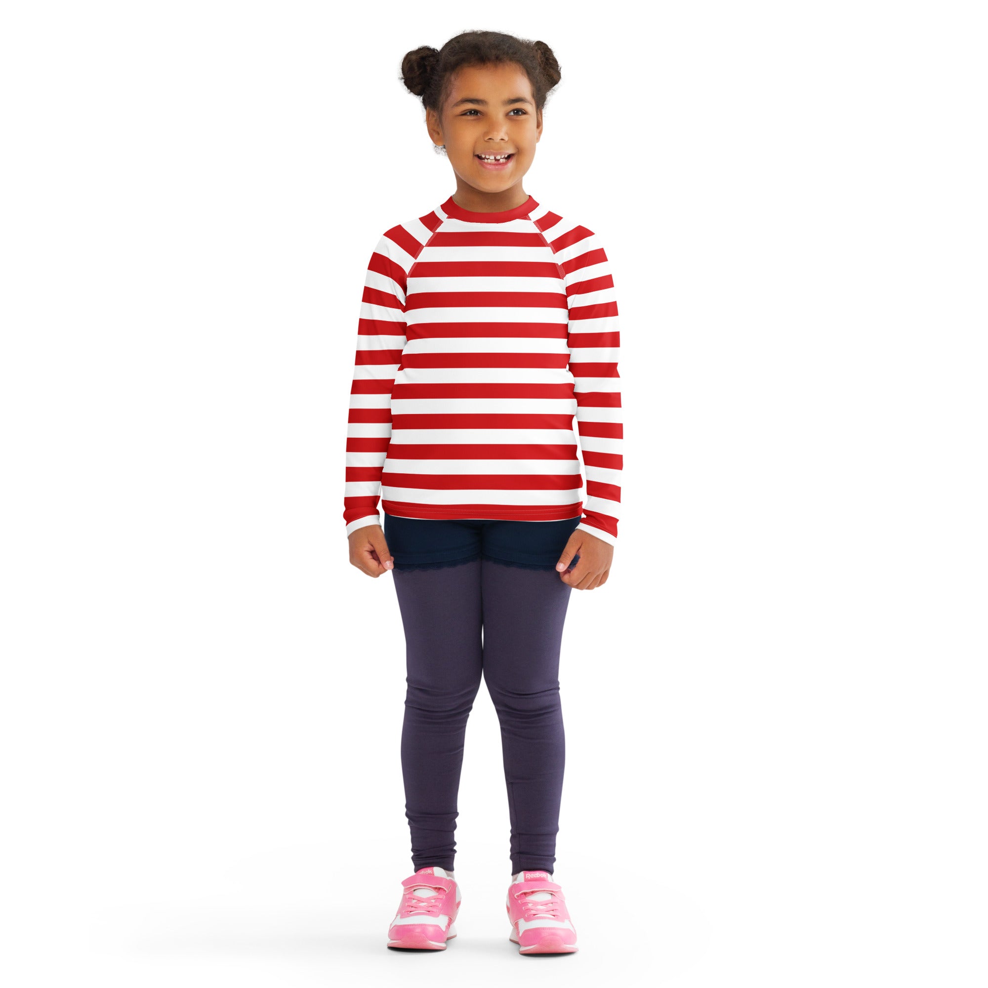 A child wearing a kids red and white striped long sleeve rash guard swim shirt with UPF 50+ and dark leggings