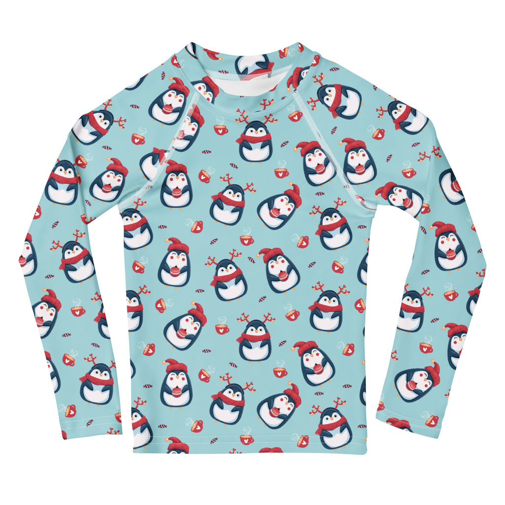 Kids reindeer penguin christmas long sleeve rash guard swim shirt in light blue with cartoon penguins and festive holiday elements