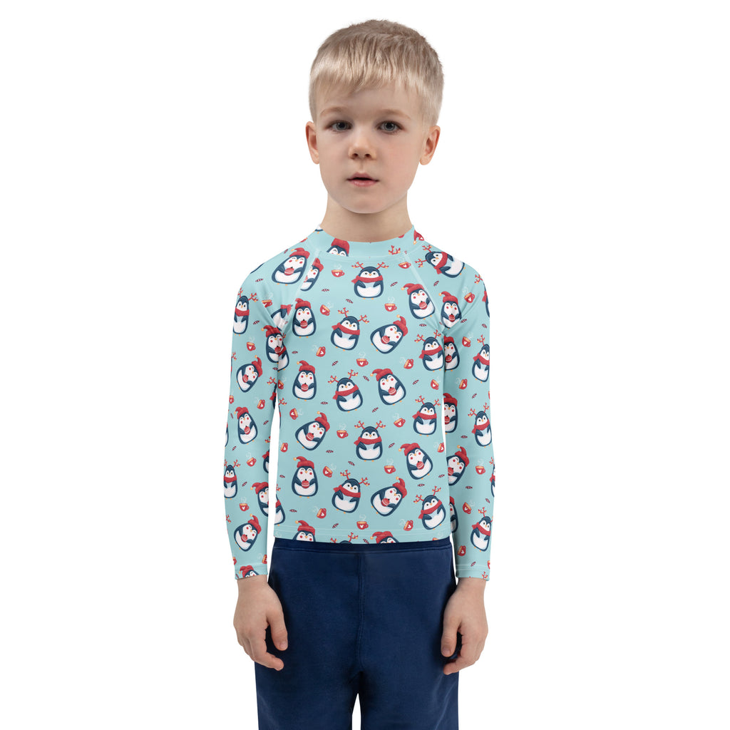 Kids reindeer penguin christmas long sleeve rash guard swim shirt in light blue with cartoon penguins and upf 50+ protection