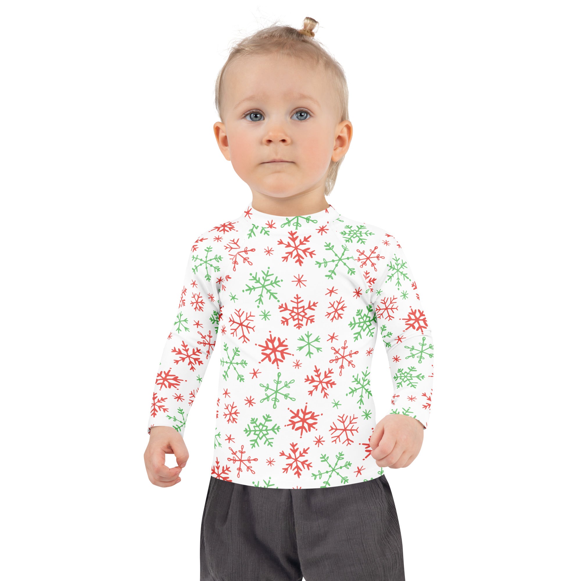 A child wearing a kids red and green snowflakes Christmas long sleeve rash guard swim shirt with UPF 50+ protection
