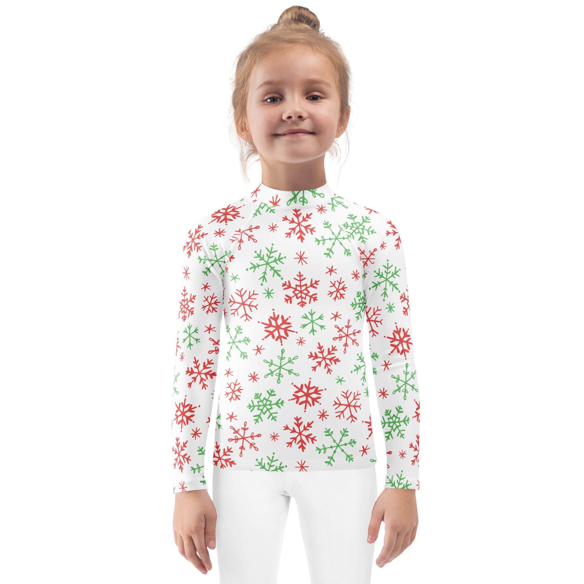 A white long-sleeved kids rash guard swim shirt with red and green snowflakes and upf 50 plus protection