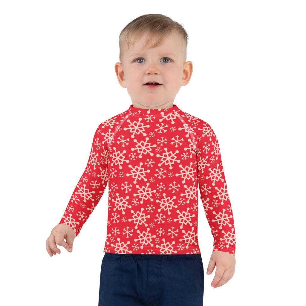 Kids red long sleeve rash guard swim shirt with white snowflake pattern and UPF 50 plus sun protection
