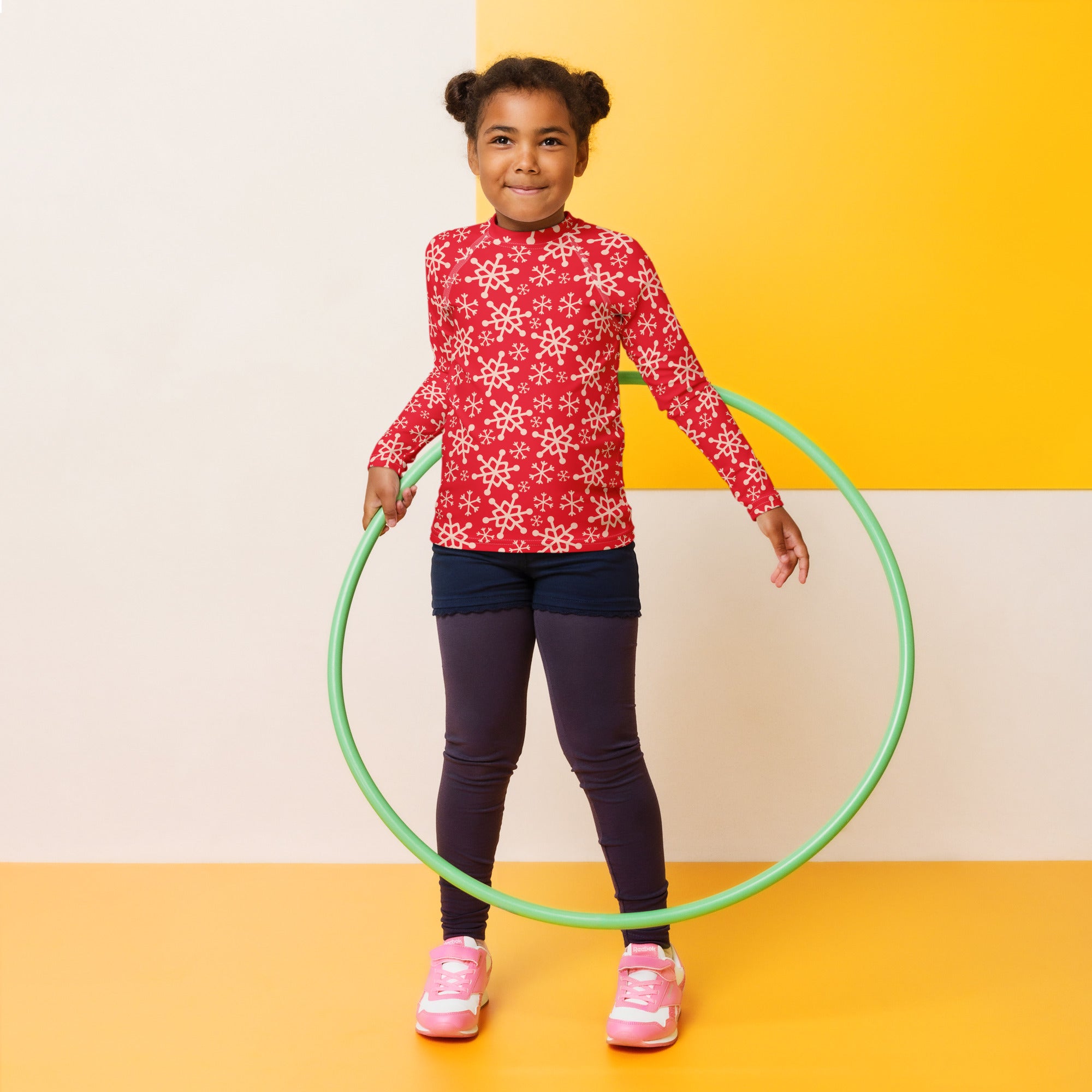 Green plastic hula hoop shown with kids red snowflake christmas long sleeve rash guard swim shirt with upf 50 plus
