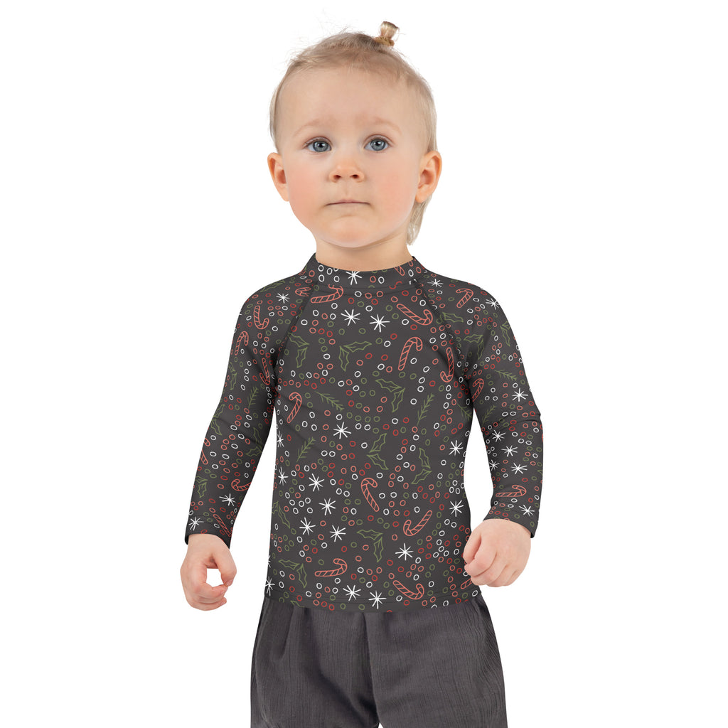 Black long-sleeved kids rash guard swim shirt with candy cane and holly pattern and upf 50+ sun protection