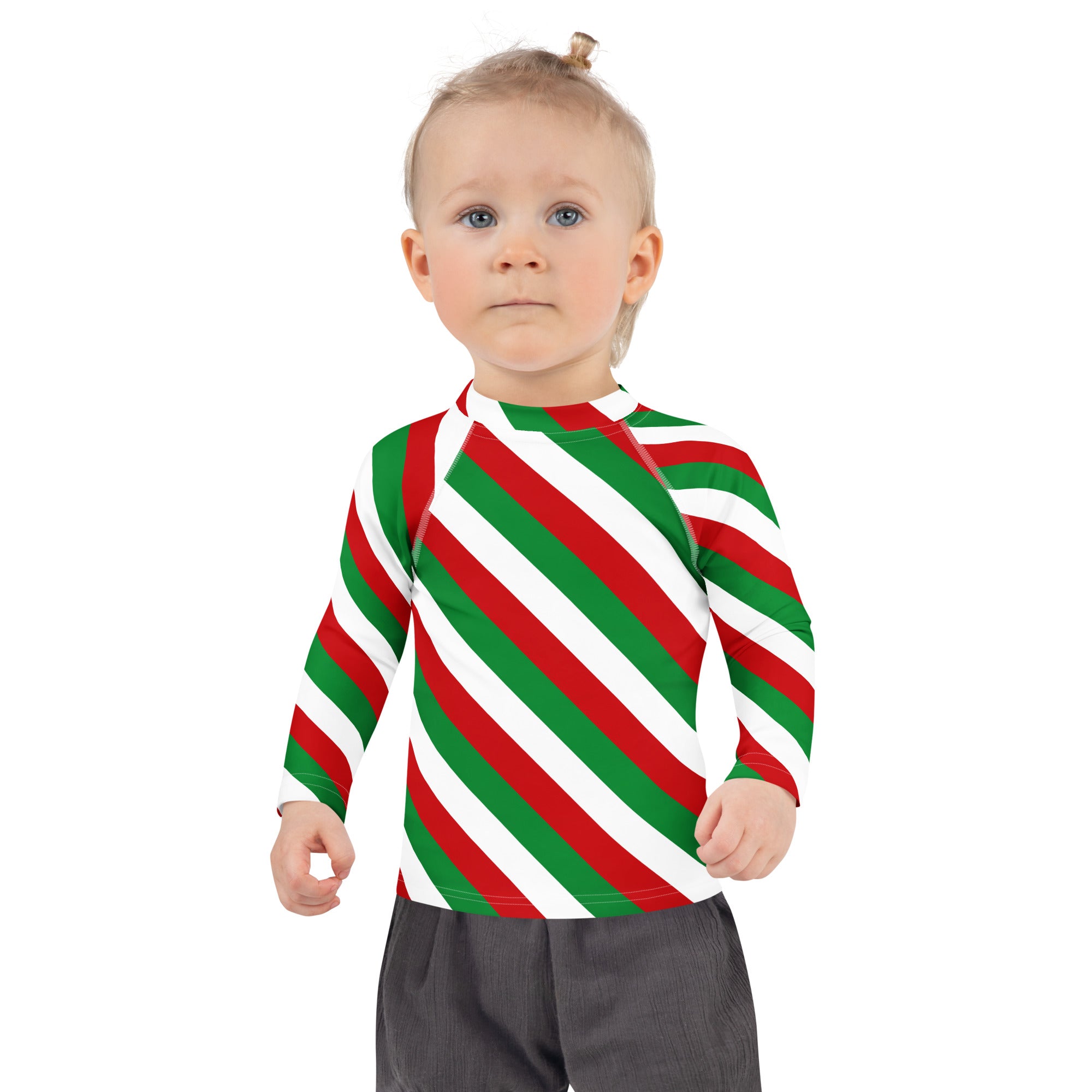 A child wearing a kids bold candy cane stripe Christmas long sleeve rash guard swim shirt with UPF 50 plus
