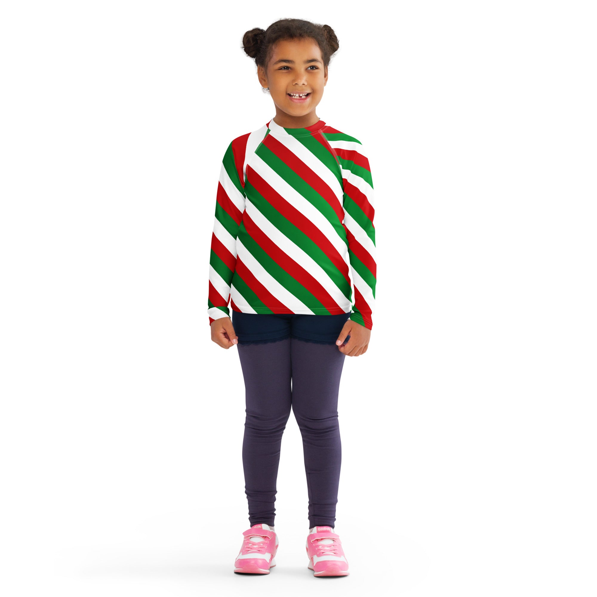 A child wearing a kids bold candy cane stripe christmas long sleeve rash guard swim shirt with UPF 50+ and red green white stripes