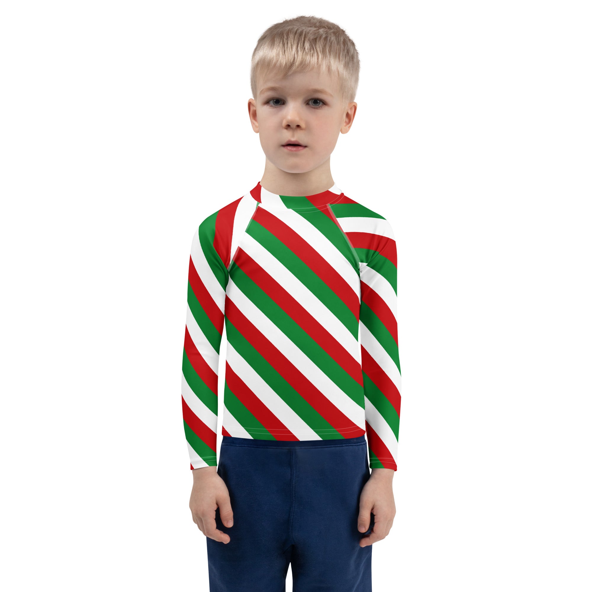 A child wearing a kids bold candy cane stripe Christmas long sleeve rash guard swim shirt with UPF 50+ and red green white diagonal stripes