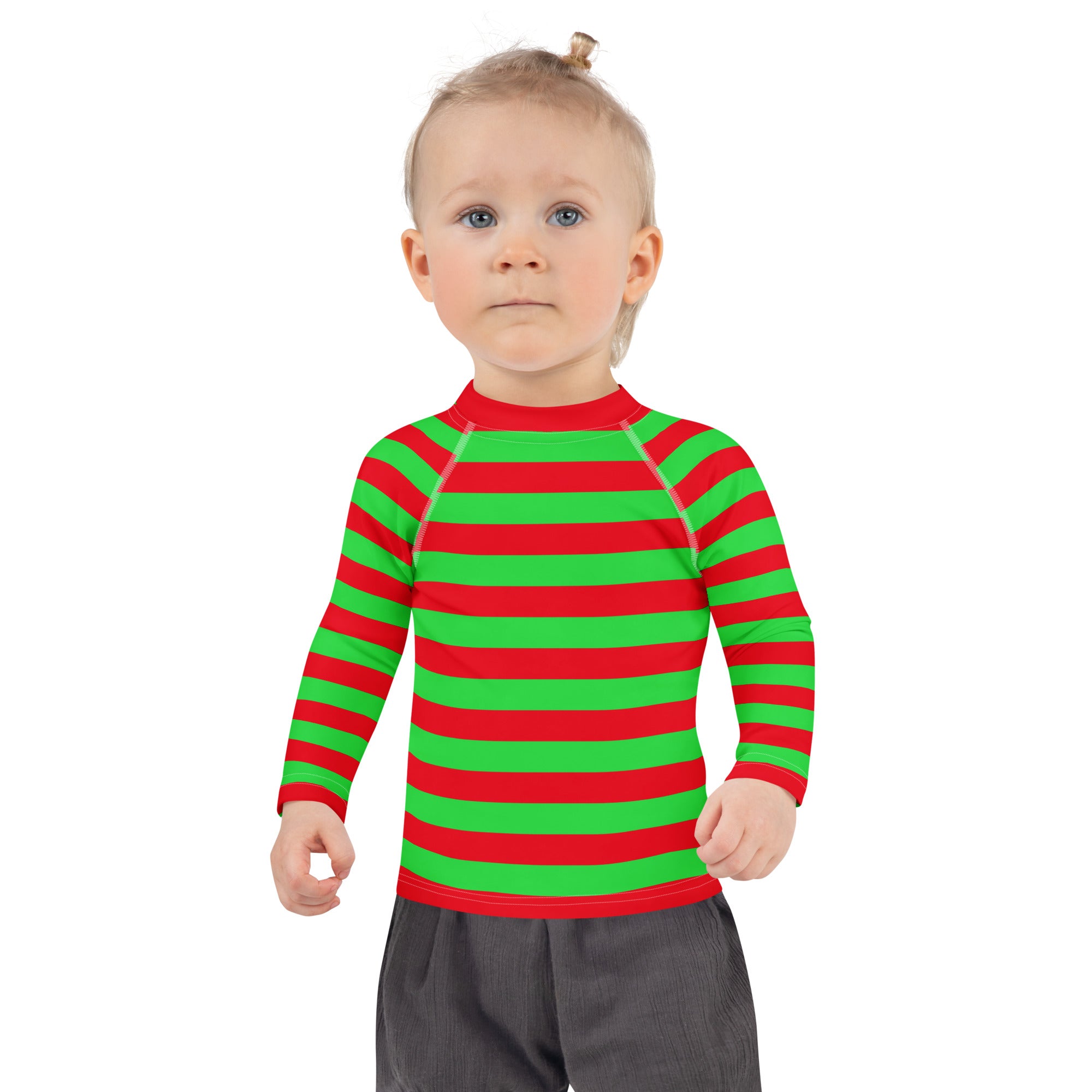 A child wearing a kids red green striped Christmas long sleeve rash guard swim shirt with UPF 50 plus protection