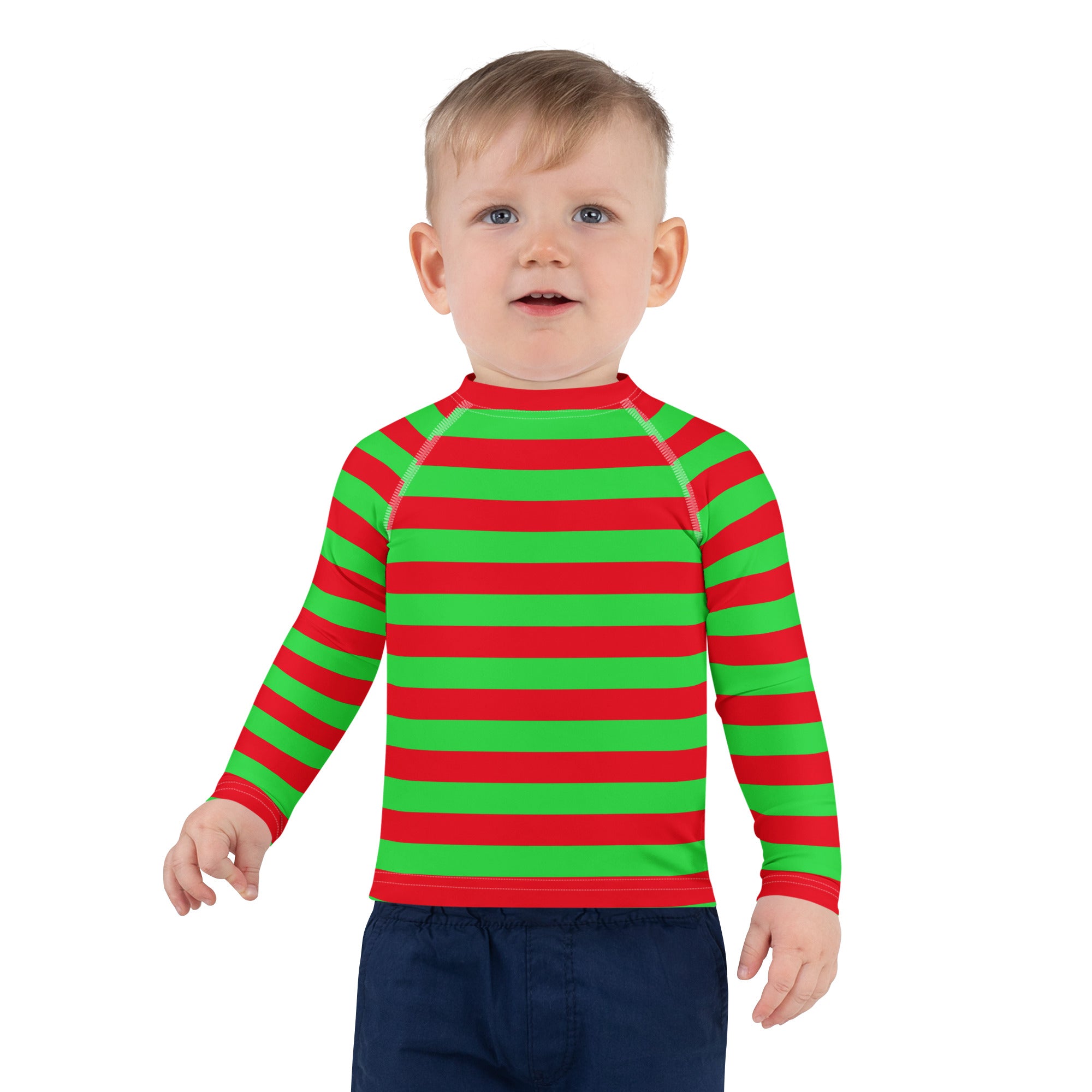 A child wearing a kids red and green striped Christmas rash guard swim shirt with UPF 50 plus long sleeves