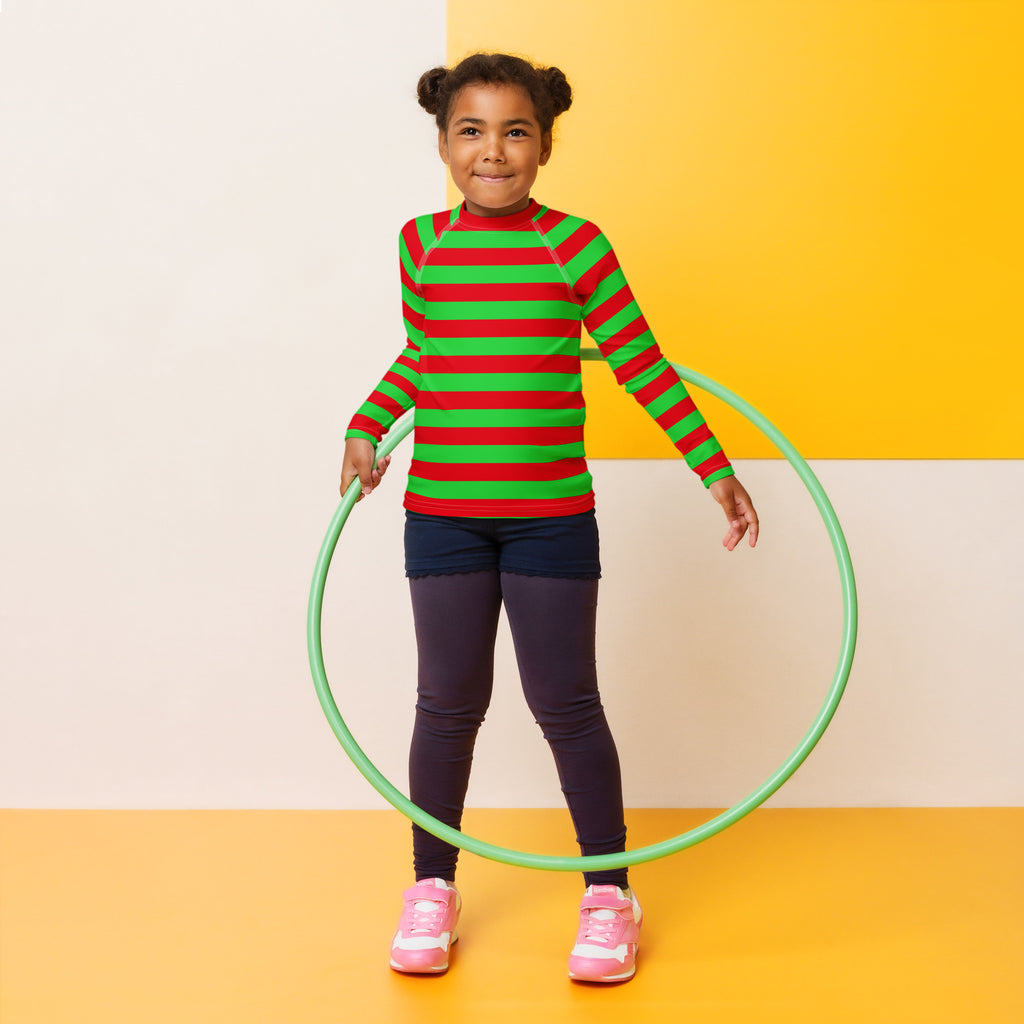 Light green plastic hula hoop displayed alongside kids red and green striped christmas long sleeve rash guard with upf 50+