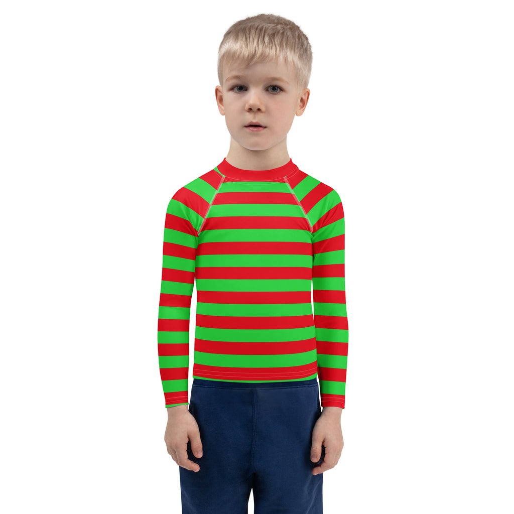 A child wearing a kids red and green striped long sleeve rash guard swim shirt with UPF 50 plus protection
