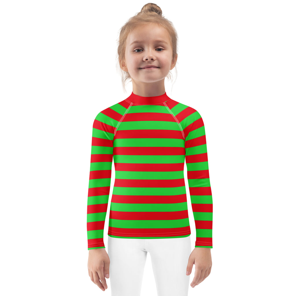 A child wearing a kids red and green striped Christmas long sleeve rash guard swim shirt with UPF 50+ protection