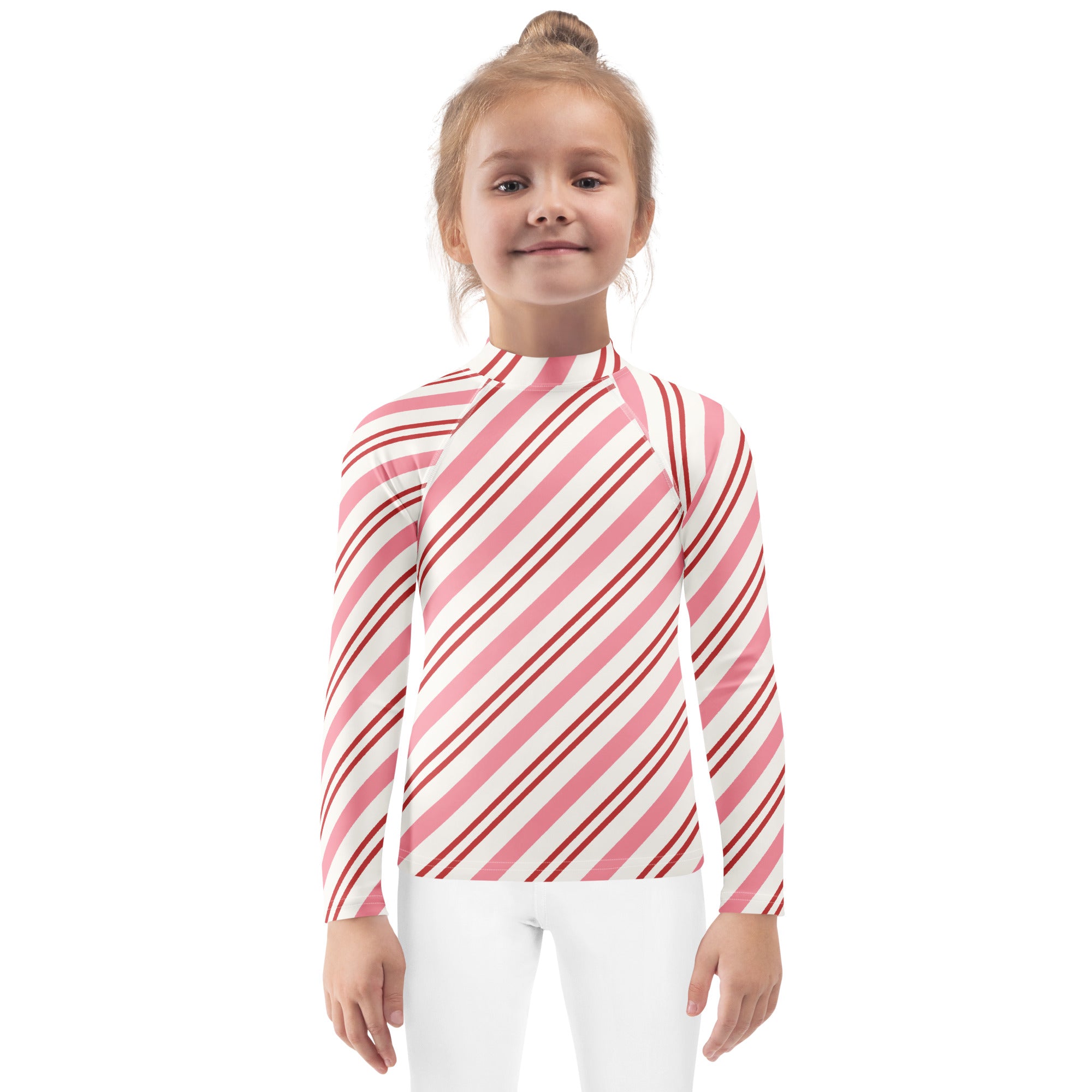 A child wearing a kids pink peppermint stripe long sleeve rash guard swim shirt with UPF 50 plus for sun protection
