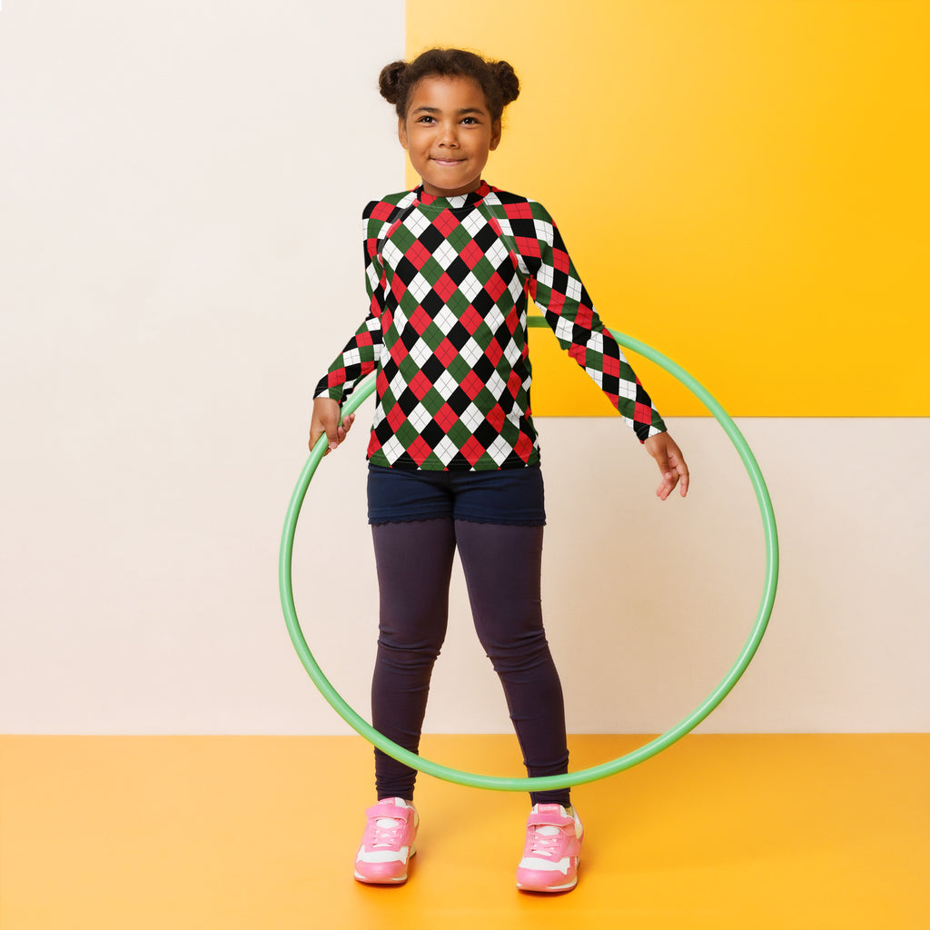 Green plastic hula hoop next to a kids christmas argyle long sleeve rash guard swim shirt with upf 50 plus
