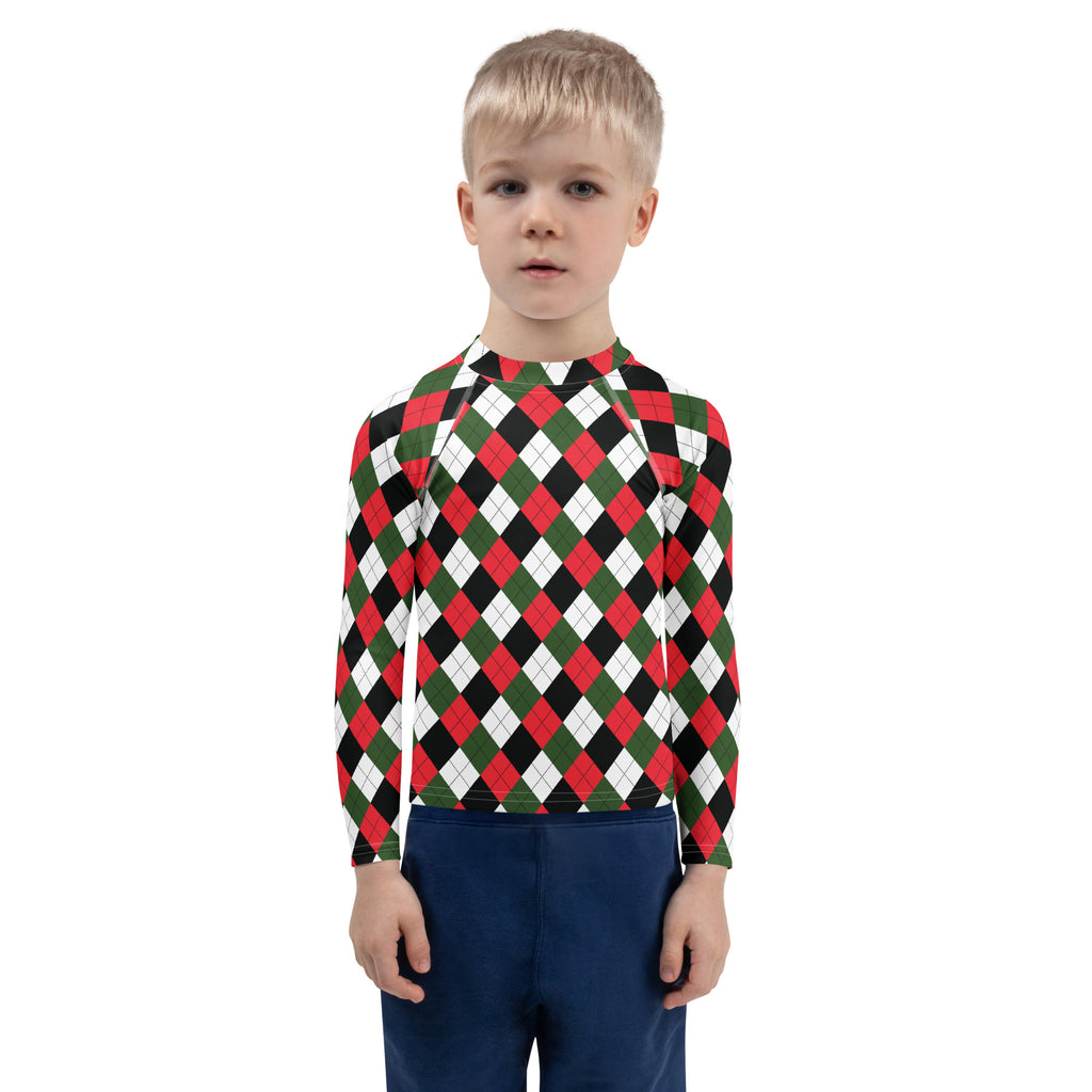 A child wearing a kids christmas argyle long sleeve rash guard with upf 50 plus in red green and black