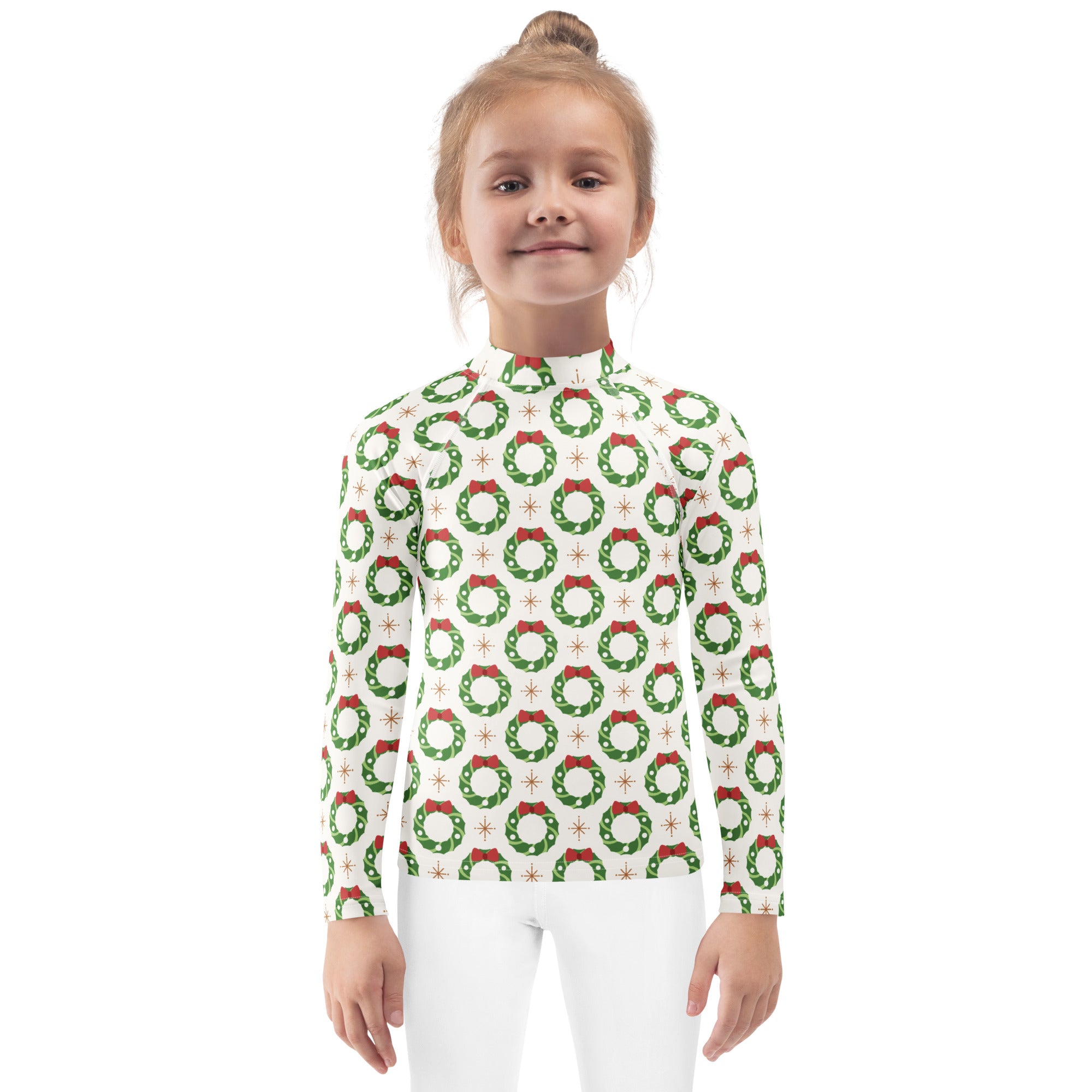 A child wearing a kids christmas wreath long sleeve rash guard swim shirt with upf 50 plus in white with green wreaths and red bows