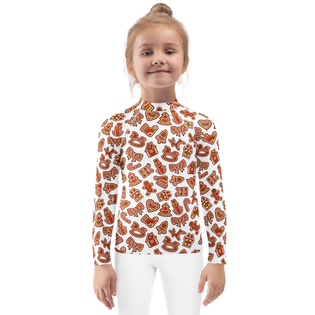 A white long-sleeved kids rash guard swim shirt with orange gingerbread cookie festive pattern and UPF 50 plus protection