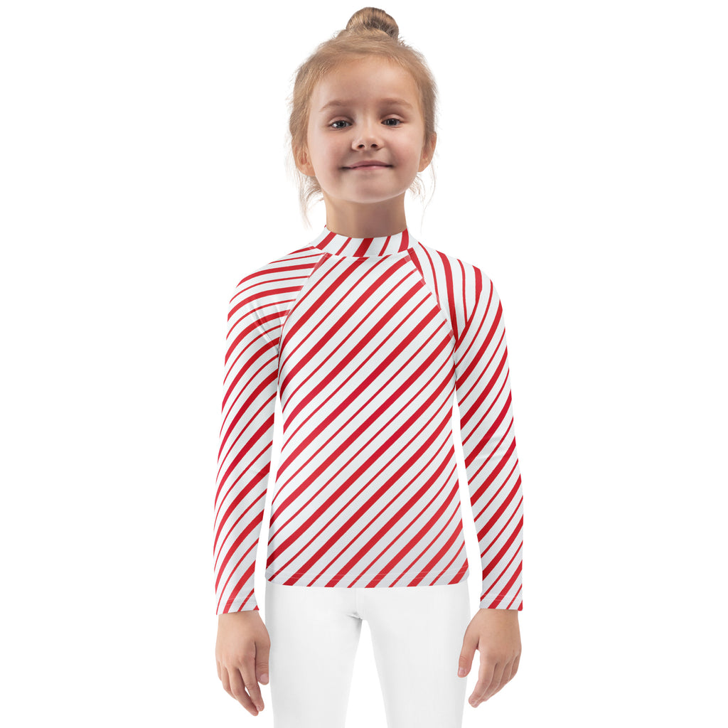 Kids red and white candy cane striped long sleeve rash guard swim shirt with upf 50 plus for sun protection