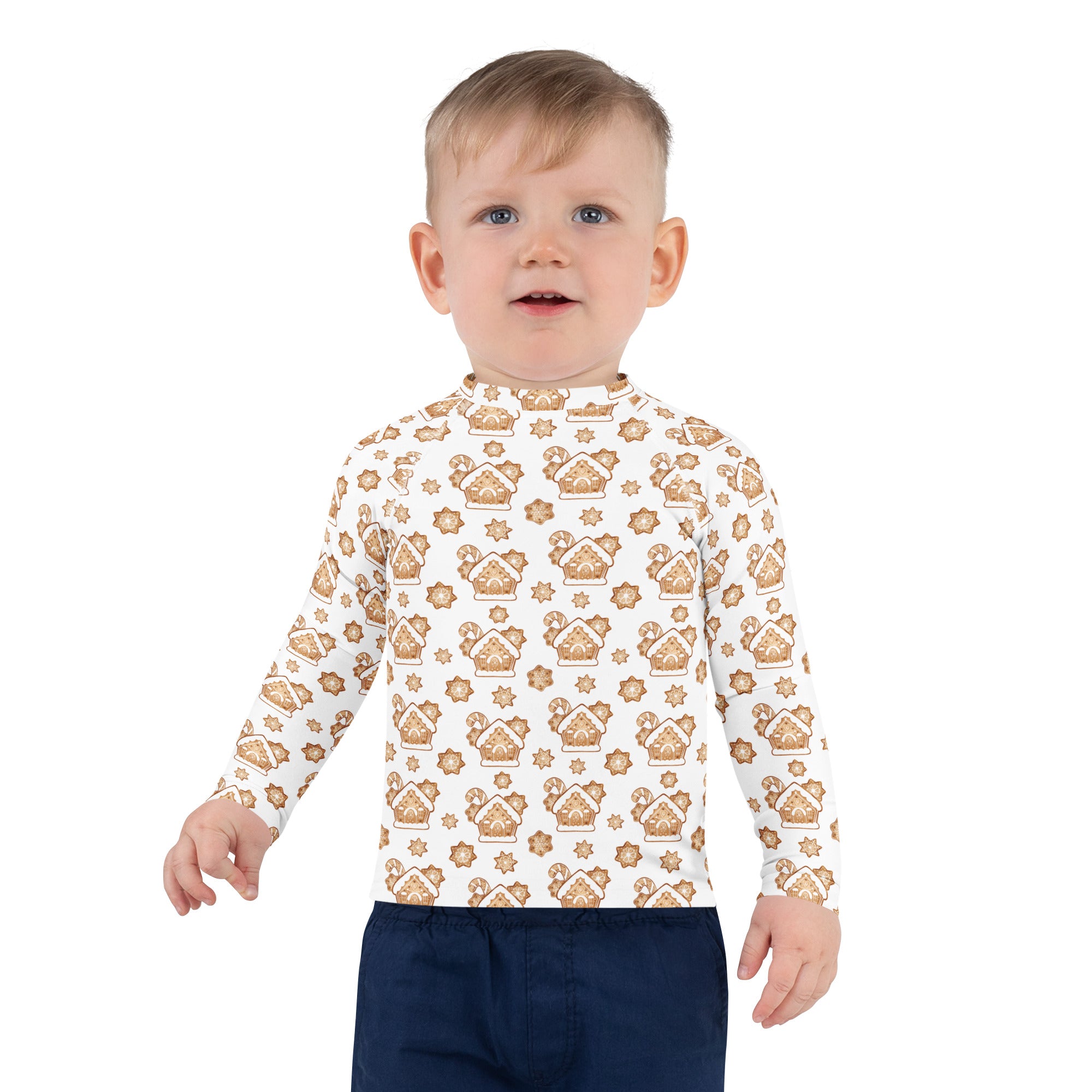 A child wearing a white kids gingerbread house christmas long sleeve rash guard swim shirt with upf 50 plus