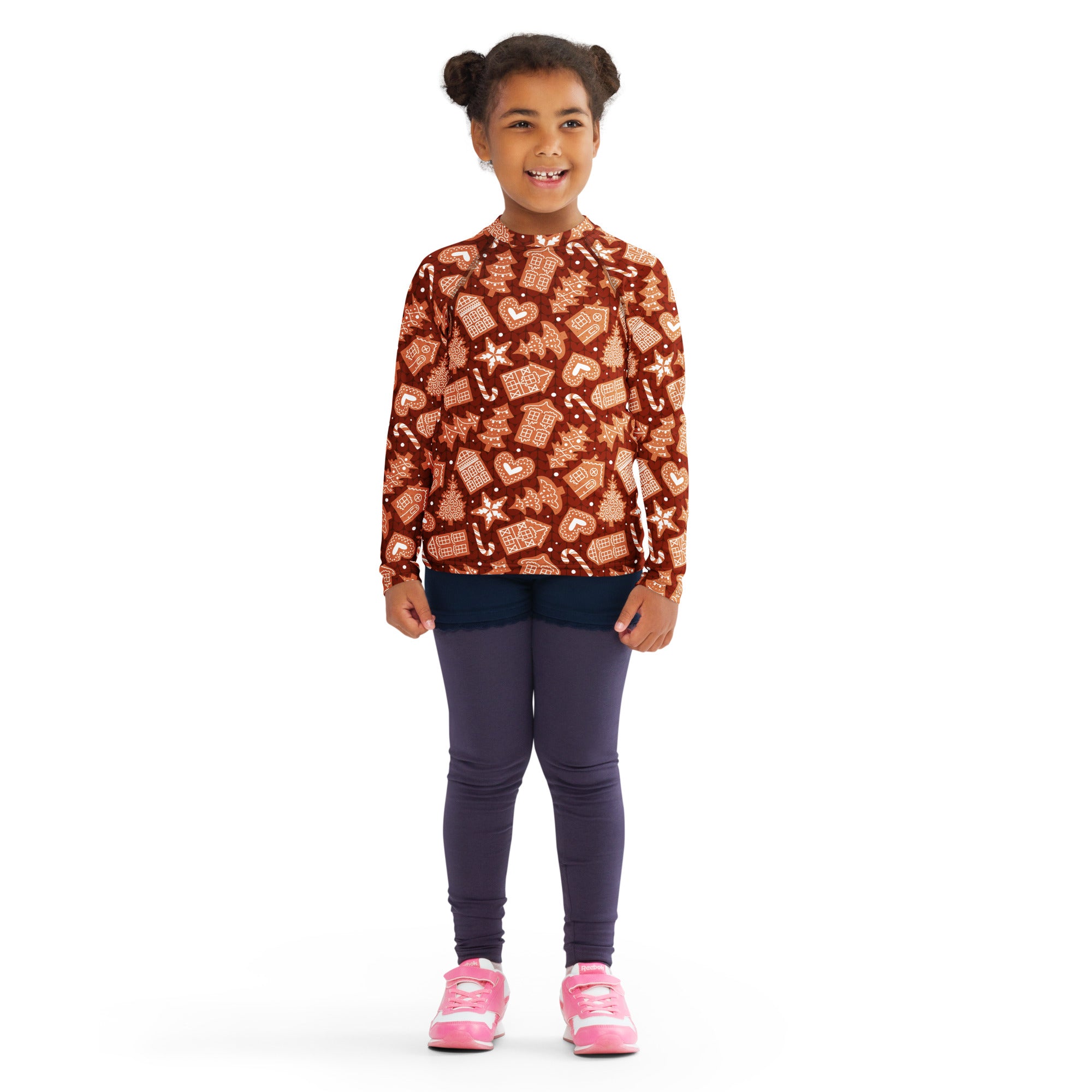 A child wearing a brown kids red gingerbread christmas long sleeve rash guard swim shirt with UPF 50 plus protection