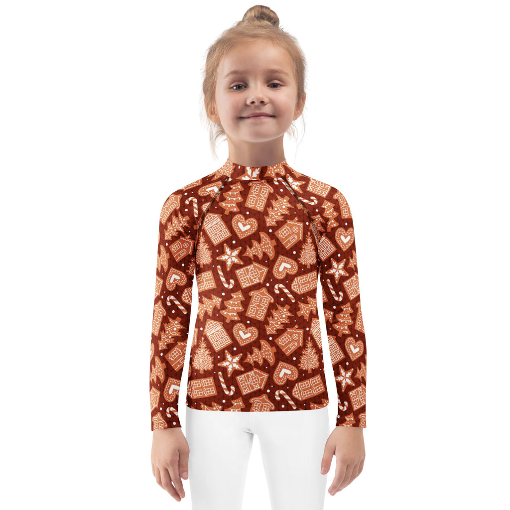 A child wearing a rust-colored kids red gingerbread christmas long sleeve rash guard swim shirt with upf 50+