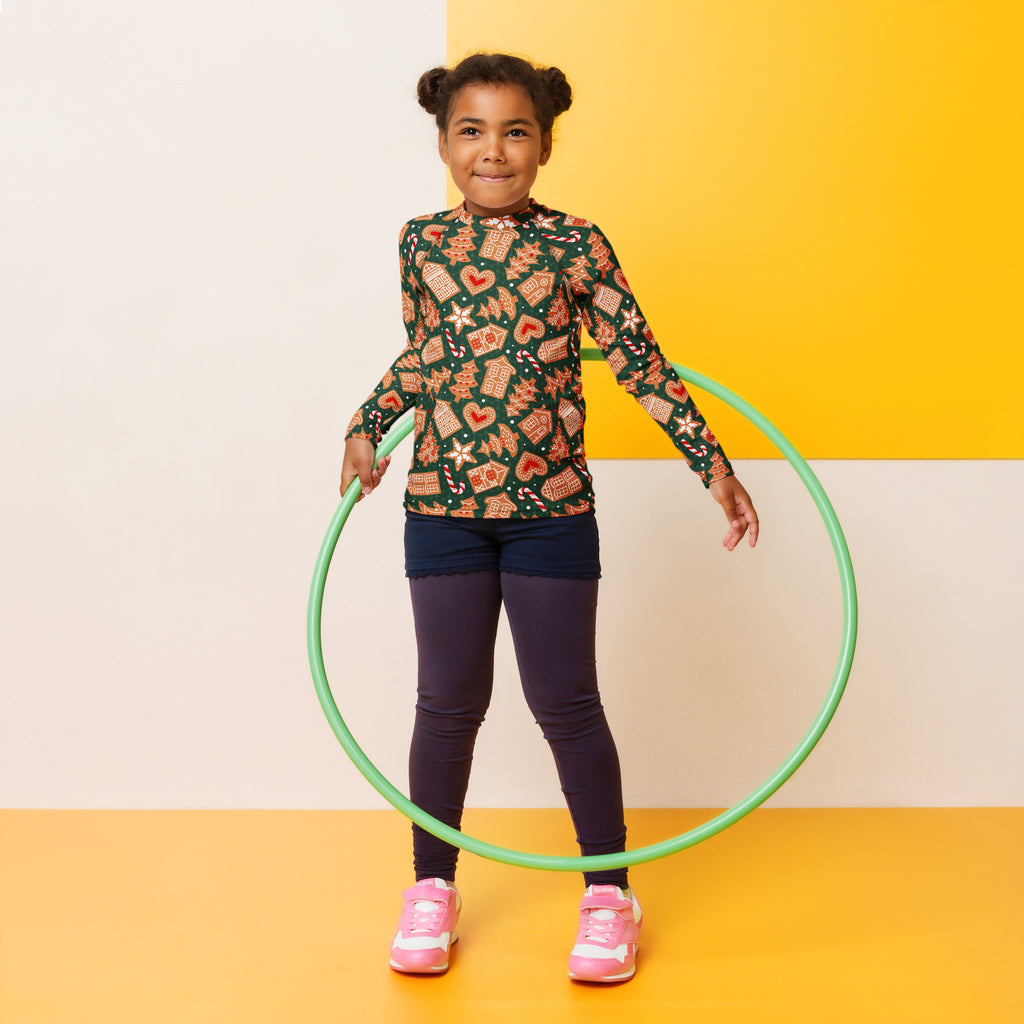 Green plastic hula hoop shown with kids green gingerbread christmas long sleeve rash guard swim shirt with upf 50+