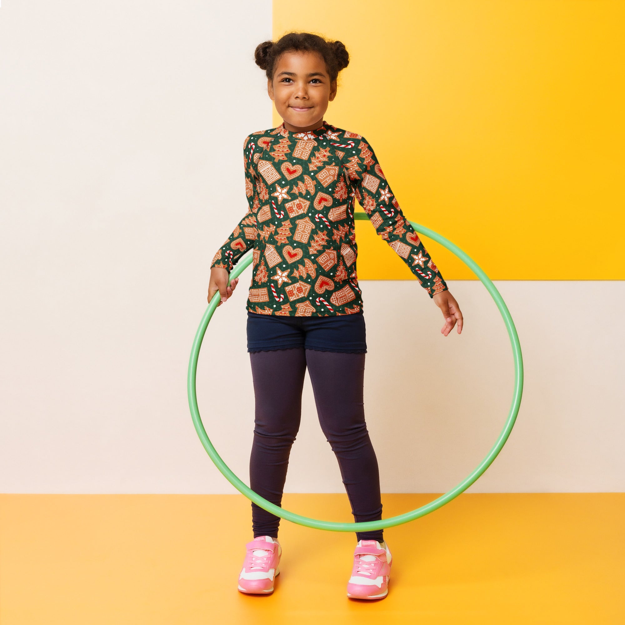 Green plastic hula hoop shown with kids green gingerbread christmas long sleeve rash guard swim shirt with upf 50+