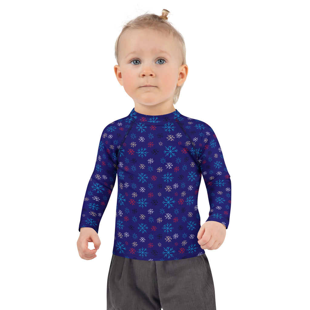 Kids navy long sleeve rash guard with light blue white and red snowflake pattern and UPF 50 plus sun protection