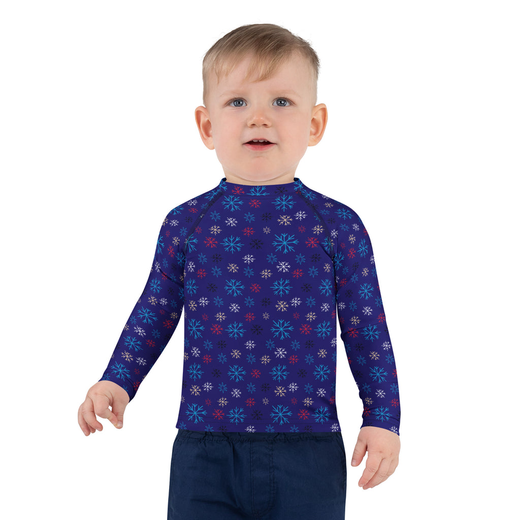 A child wearing a kids navy snowflake Christmas long sleeve rash guard swim shirt with UPF 50 and colorful patterns