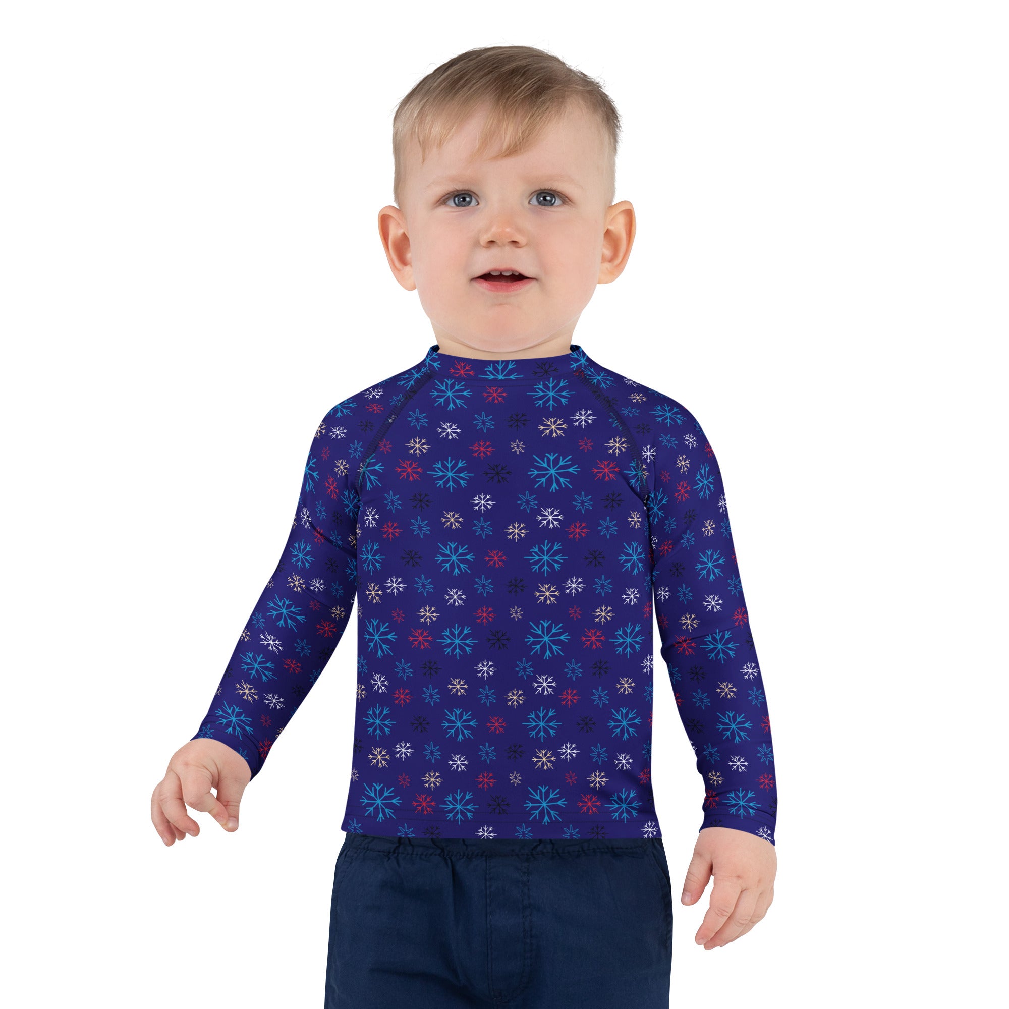 A child wearing a kids navy snowflake Christmas long sleeve rash guard swim shirt with UPF 50 and colorful patterns