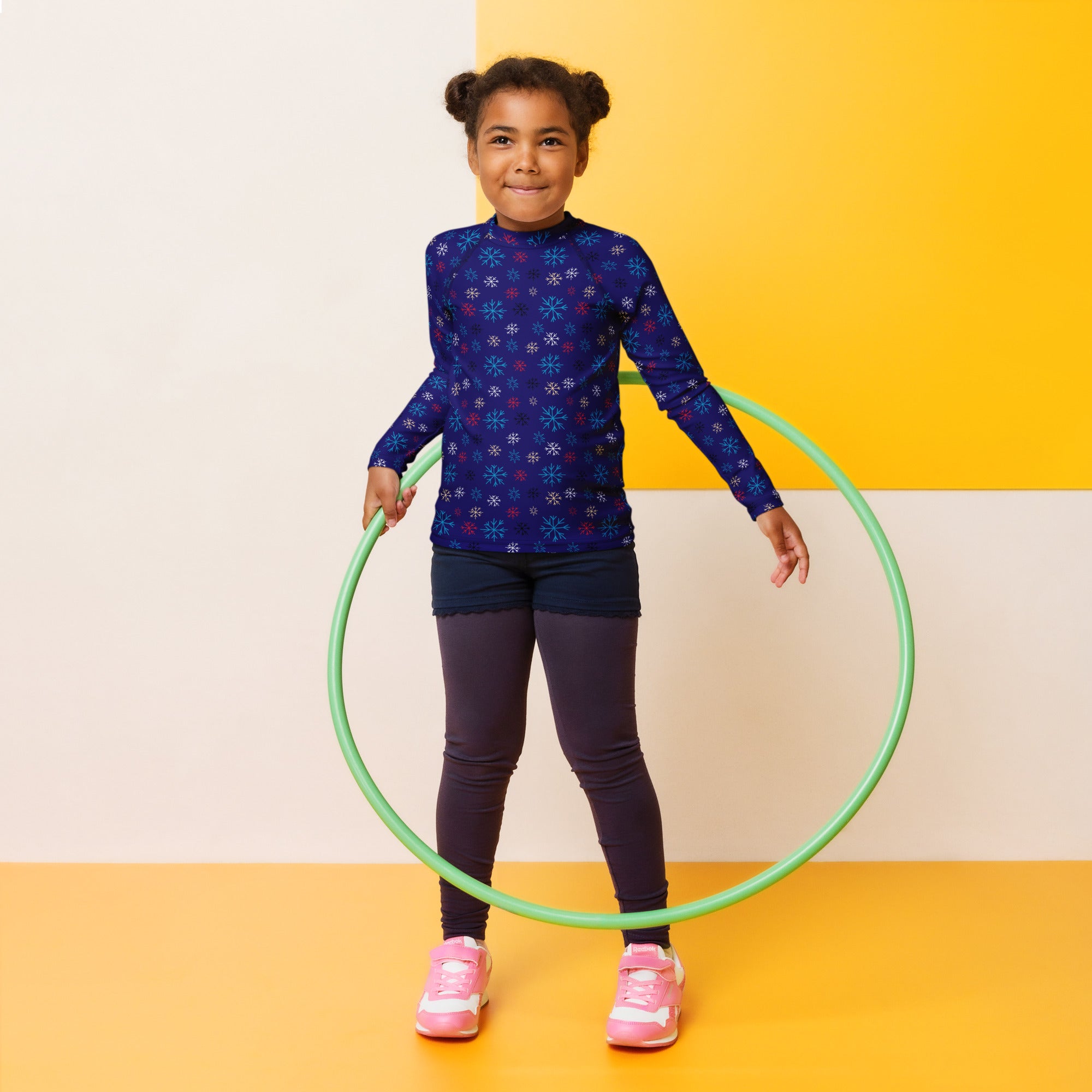 Green plastic hula hoop shown with kids navy snowflake christmas long sleeve rash guard swim shirt with upf 50 plus
