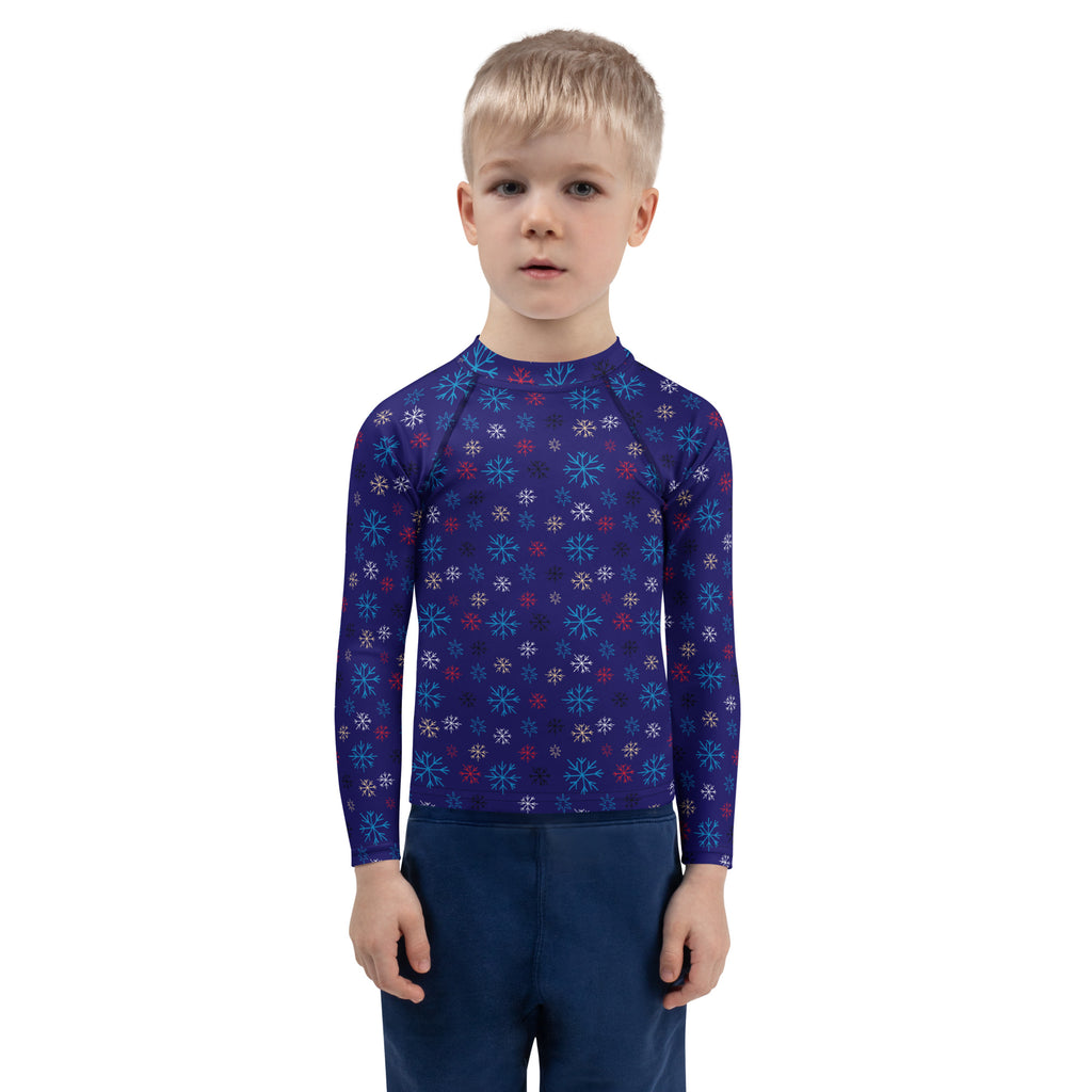 Kids navy blue long sleeve rash guard swim shirt with multicolored snowflake pattern and UPF 50 plus protection