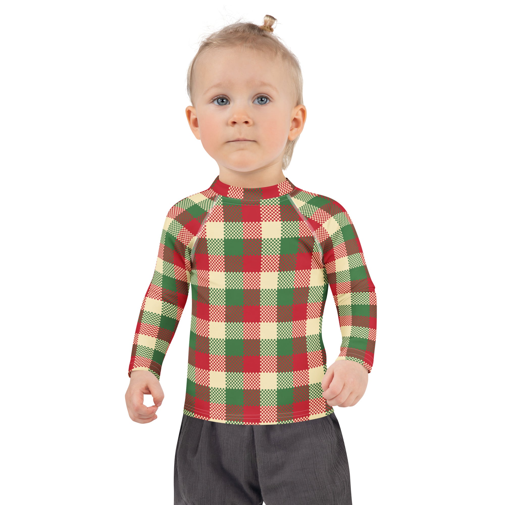 A child wearing a kids christmas plaid long sleeve rash guard swim shirt with upf 50 plus in red green and cream