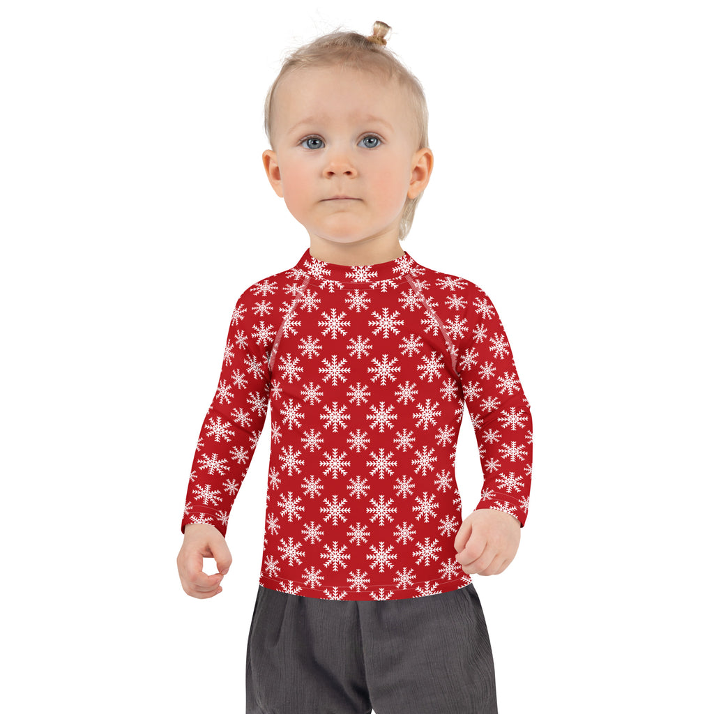 Kids red long sleeve rash guard swim shirt with white snowflake pattern and UPF 50 plus for sun protection