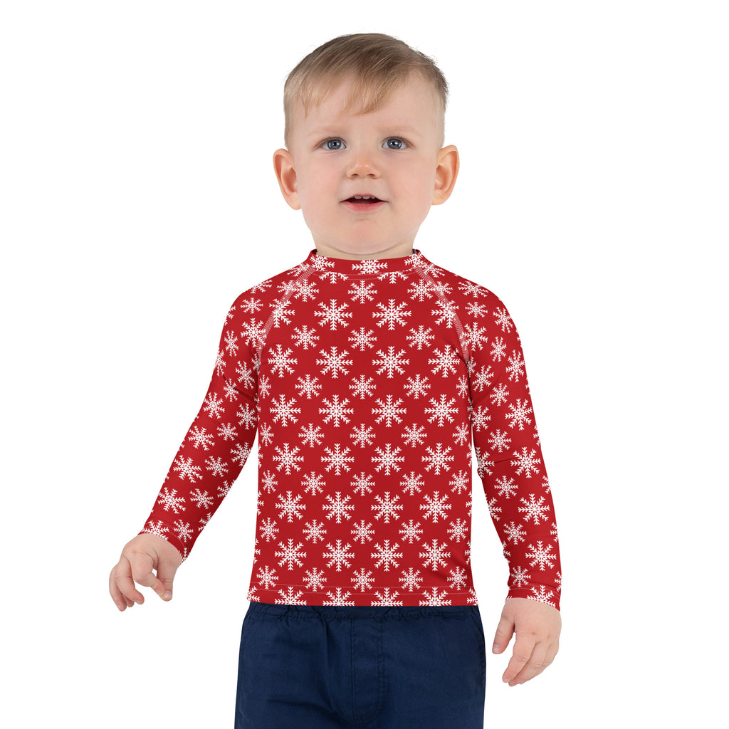 Kids red long sleeve rash guard swim shirt with white snowflake pattern and UPF 50 plus sun protection